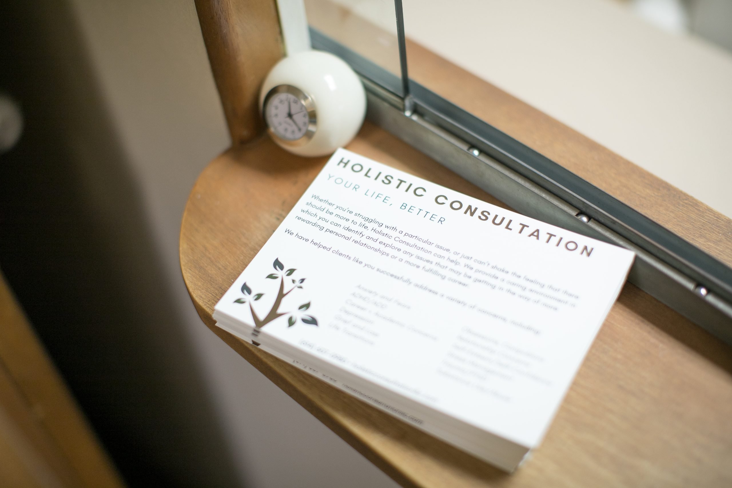 Holistic Consultation LLC brochure on office windowsill, Columbus Ohio counseling practice