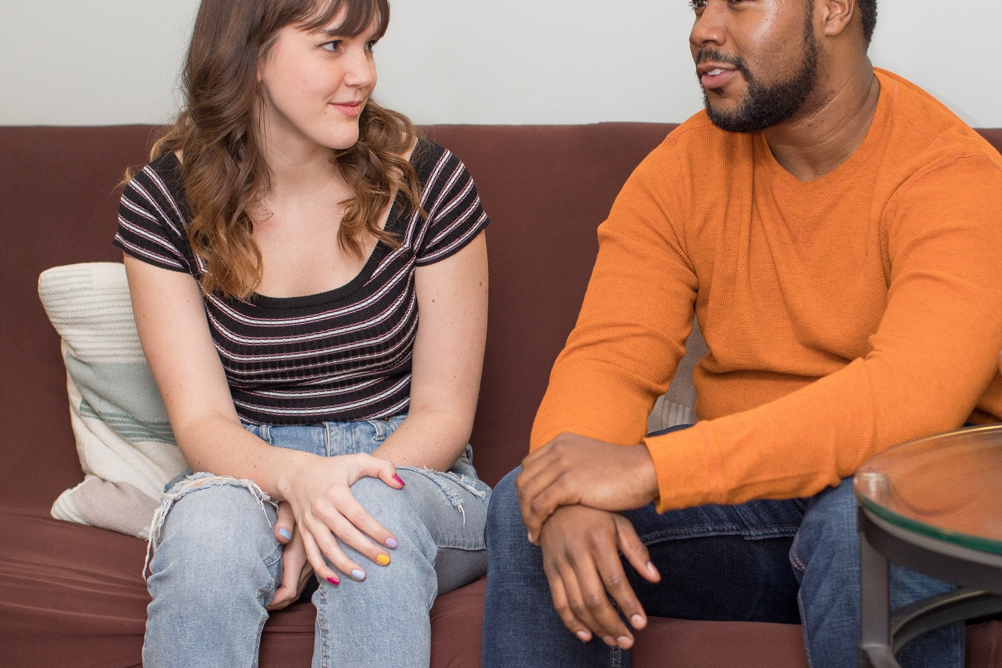 Man and woman having an open conversation together on a couch, representing couples therapy in Columbus, Ohio