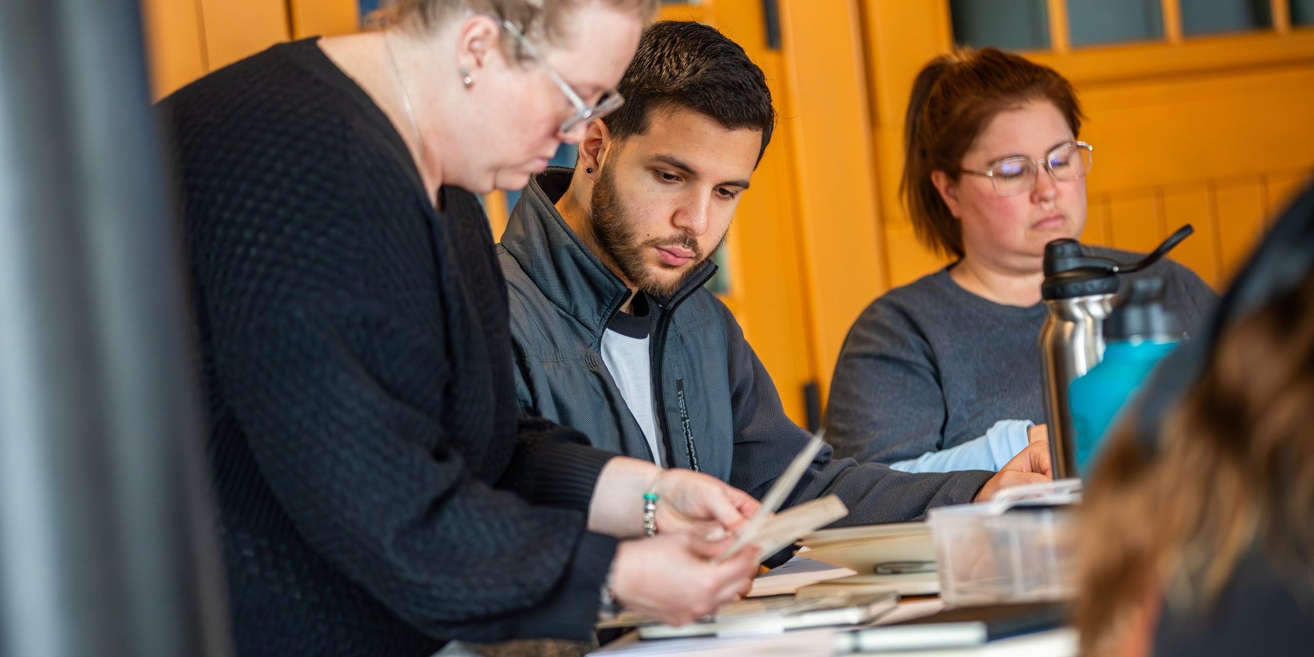 Team members reviewing materials together during a professional development session at Holistic Consultation in Columbus, Ohio