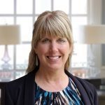 Julie Koloc, MA, LPCC, LMHC, smiling therapist providing online therapy across Ohio, specializing in trauma and somatic-focused care