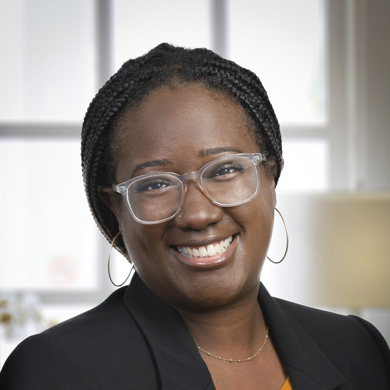 Megan Torres, MSW, LISW, smiling therapist providing telehealth therapy across Ohio, specializing in care for Queer and BIPOC communities